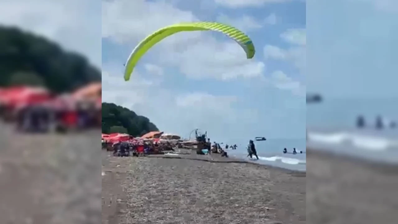 Yamaç paraşütü ile havalanmak istedi: Tatilcilerin arasına daldı