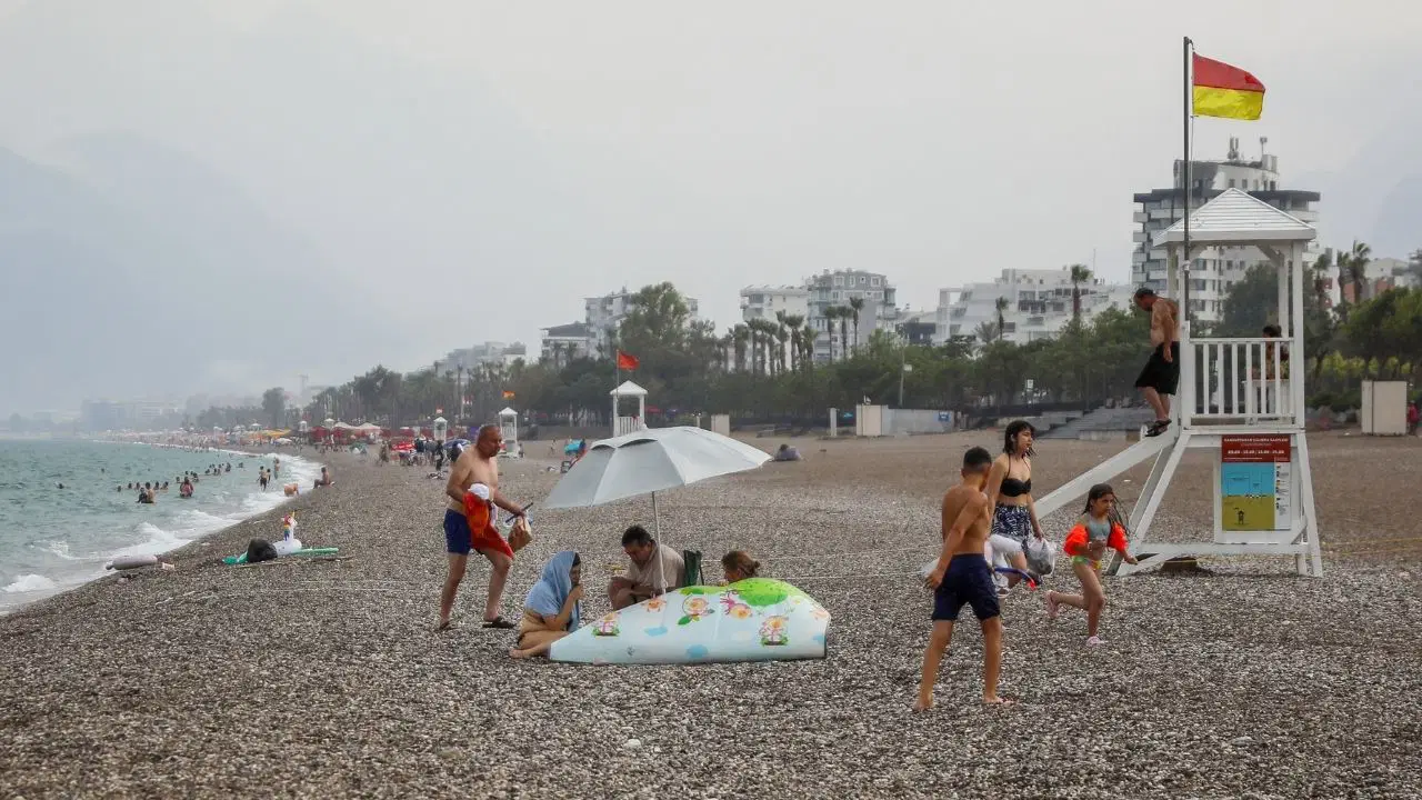 Antalya'da sağanak yağış: Bazı tatilciler denizde yüzmeye devam etti